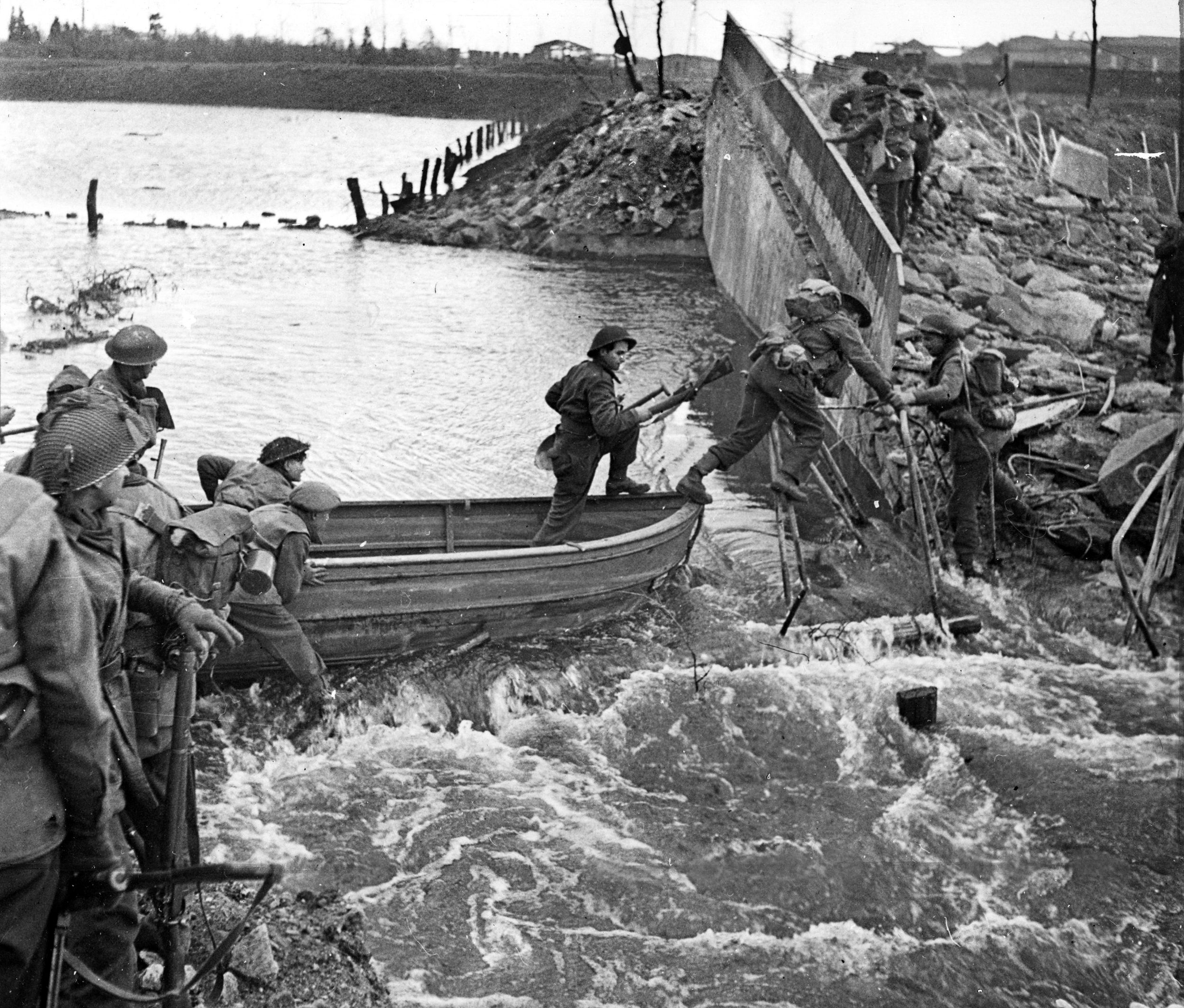 British soldiers cross the Niers River on March 2, 1945, heading for the nearby town of Weeze, Germany. The Germans disabled dams to allow normally small rivers to overflow their banks. Some floodwaters took as long as two weeks to recede.