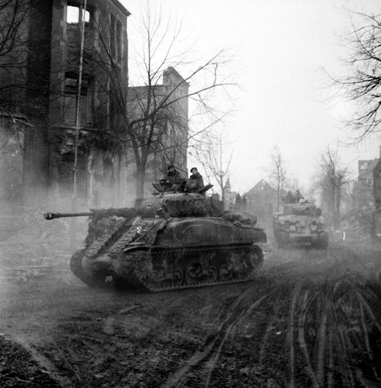 Sherman Firefly tanks moving through Cleve in the Rhineland on February 16, 1945, on the way to take the town of Goch. A British innovation, the Firefly was an M4 Sherman fitted with a high-velocity 17-pound (76.2mm) gun more suited for combat against other tanks.