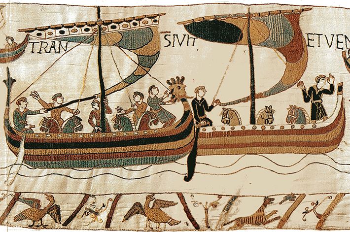 A closeup of the 11th century Bayeaux Tapestry depicting William, Duke of Normandy, leading boats full of horses and men across the channel to England in 1066.