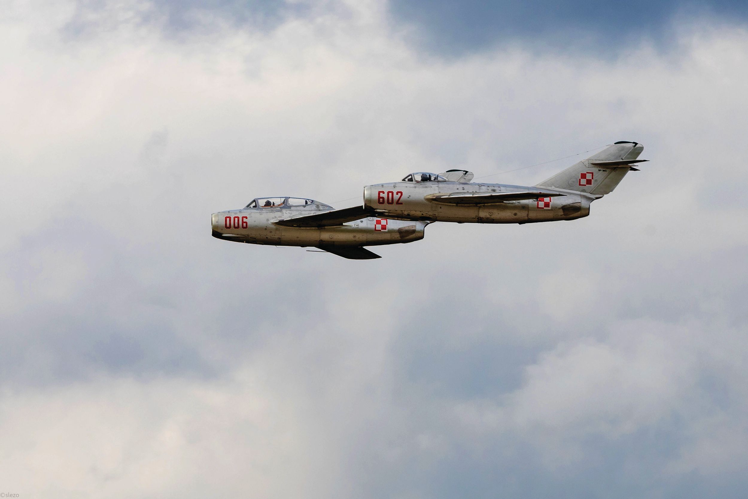 Two Cold War-era Soviet MiG-15s fly in formation at the Slovak international Air Show in 2022.