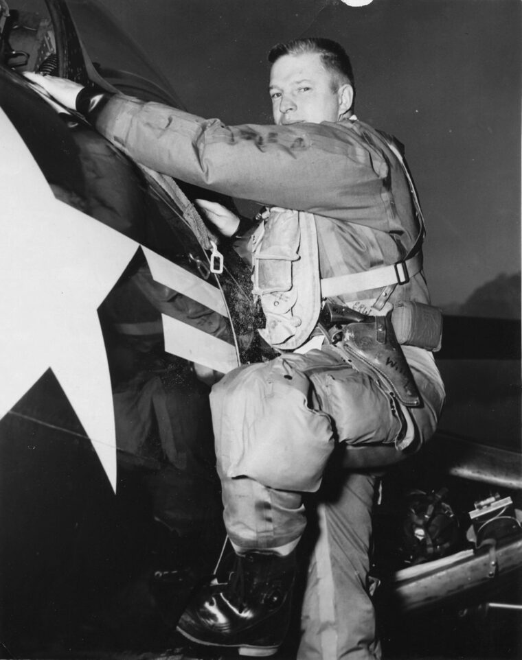 Navy Lieutenant Royce Williams climbs into his F9F Panther. Williams shot down four Soviet MiG-15s off the coast of Korea in an incident classified for 50 years. In January 2023, he received the Navy Cross. 