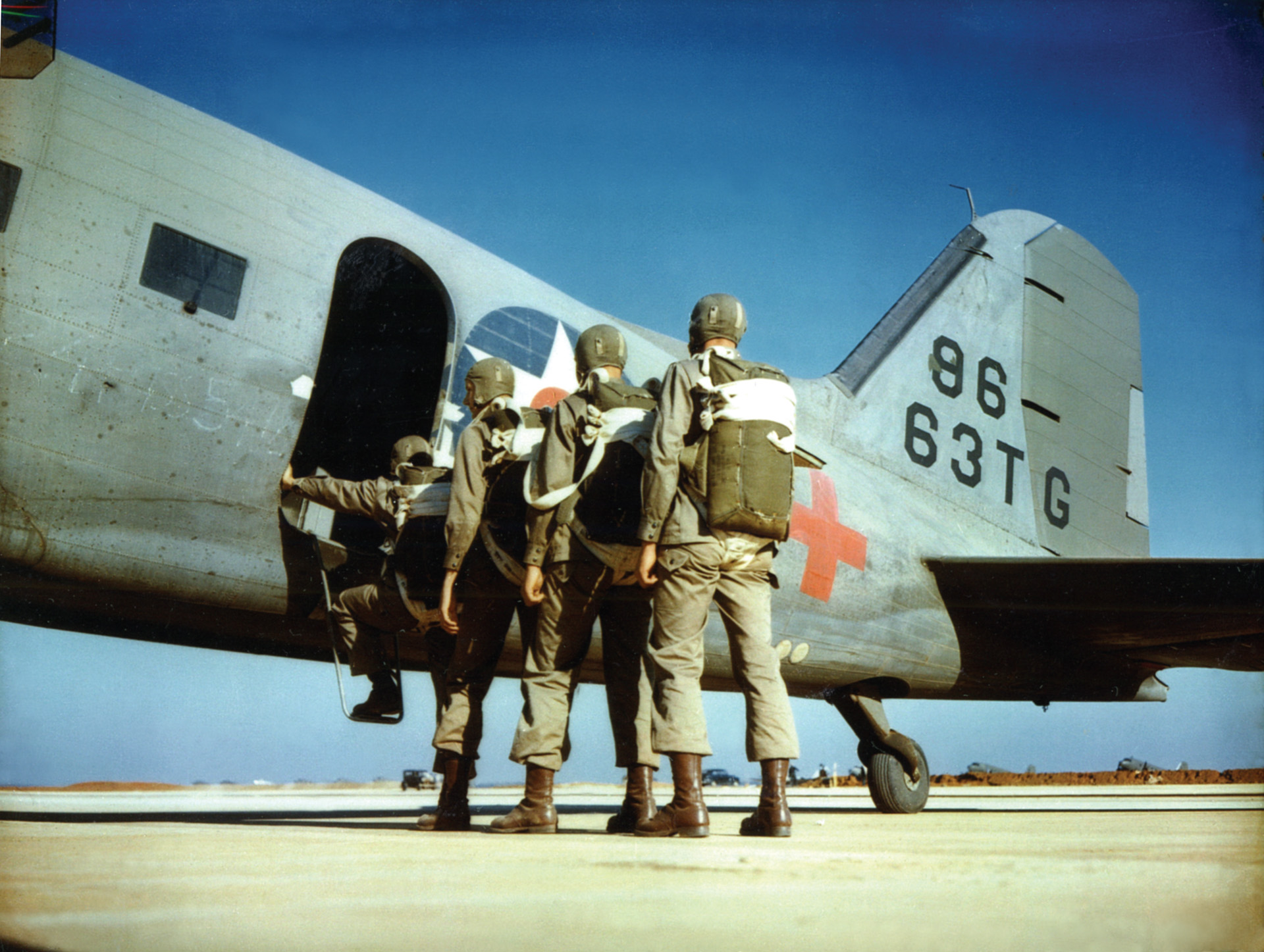 New recruits wearing soft headgear board a C-47 for their first practice jump.