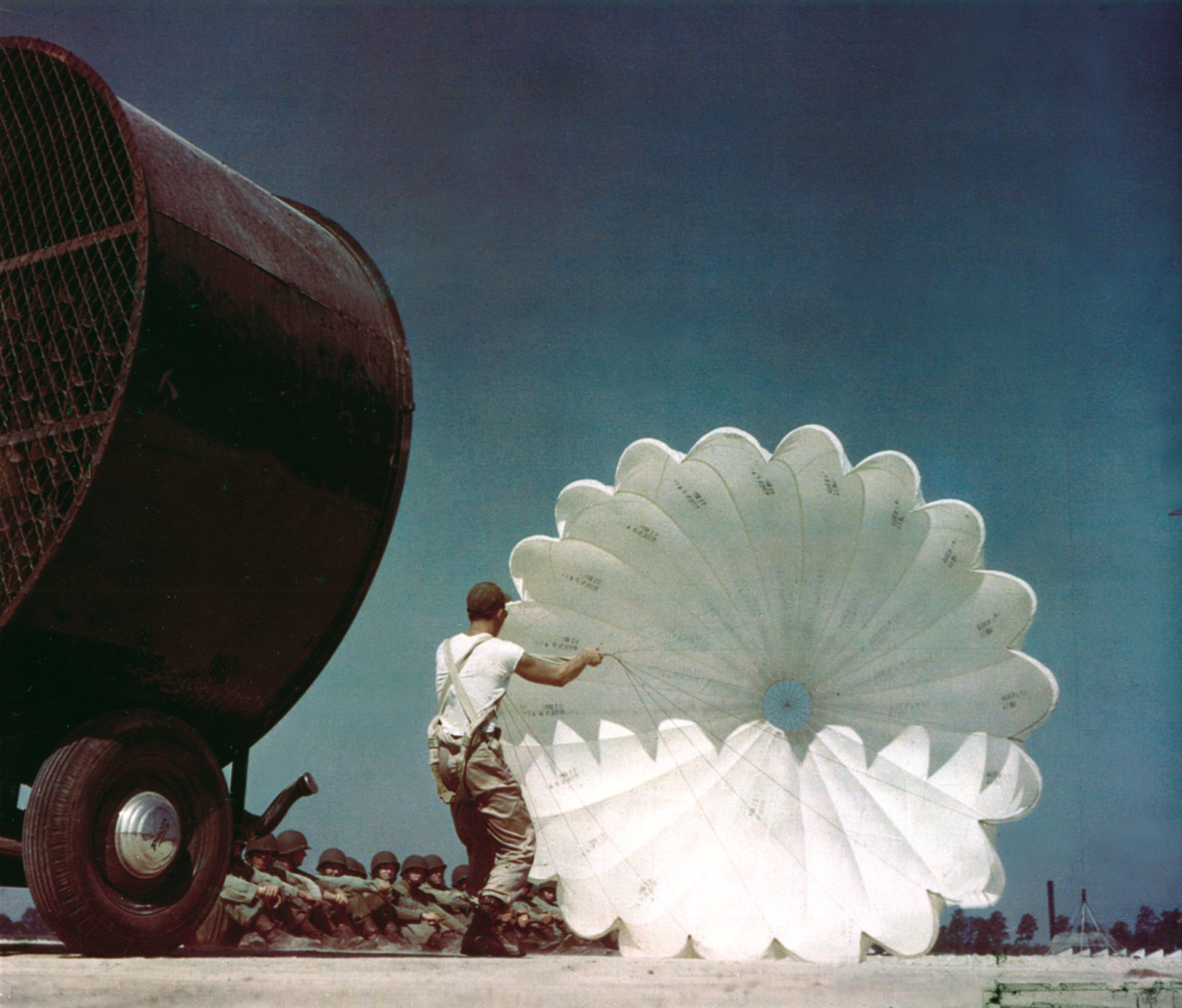 An instructor demonstrates how to collapse a parachute to a class of Airborne hopefuls at Fort Benning.