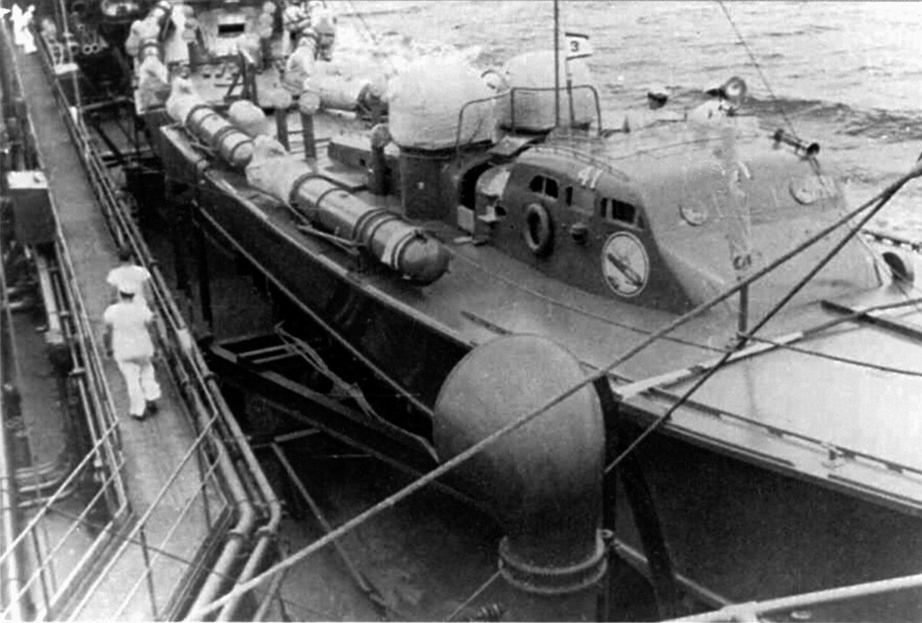 Riding alongside a navy tanker, PT-41 is seen making its way toward the Philippines with five other PT boats of MTB Squadron 3.