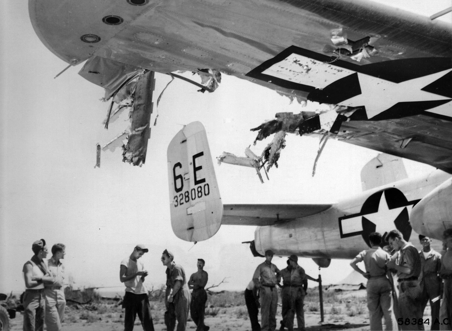 This North American B-25 Mitchell bomber took a direct hit from German flak over southern France but managed to land safely at its base during the harrowing 1944 mission. The damage to the right wing is extensive, as evidenced in the photo. 