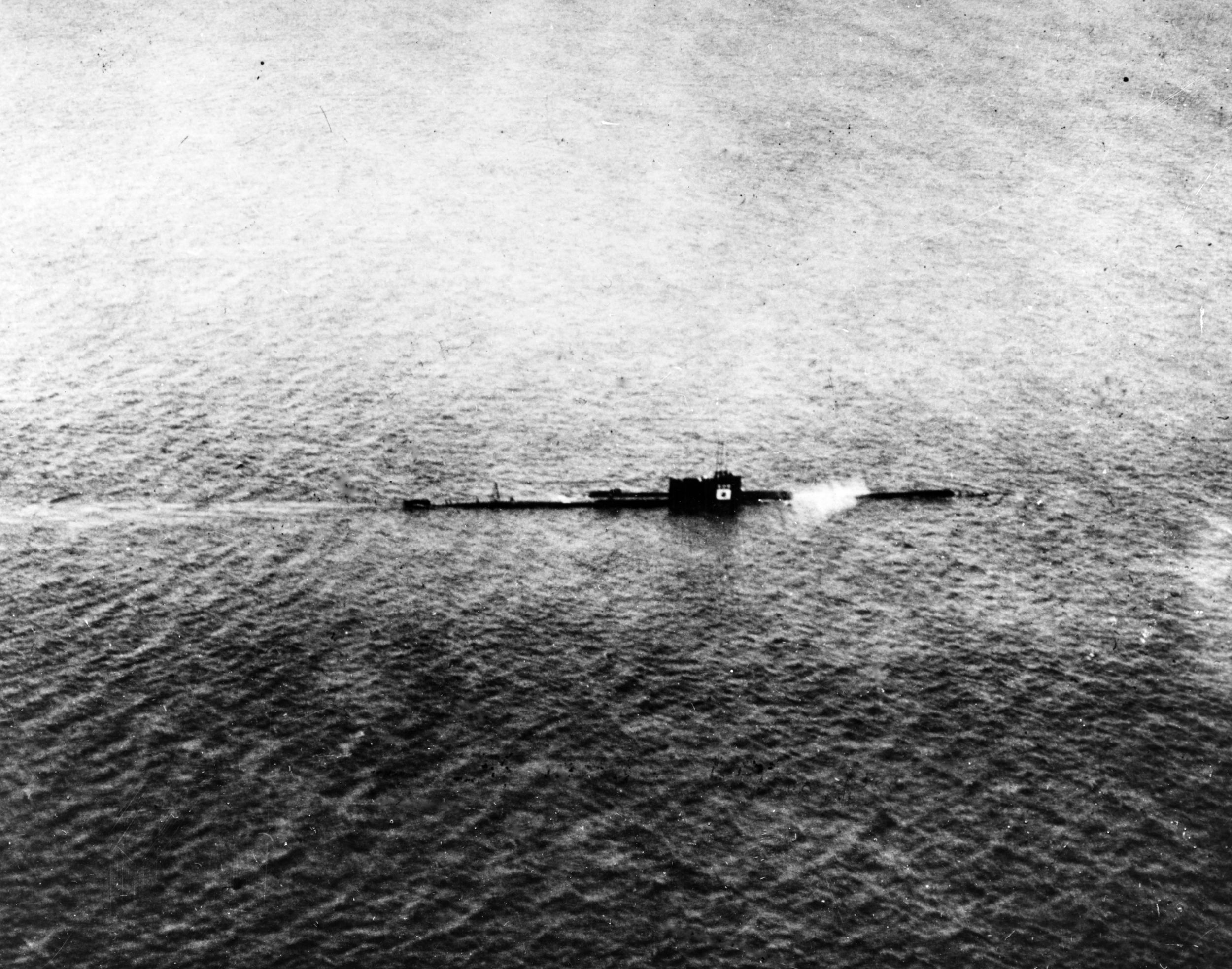 An unidentified Japanese submarine is photographed from the air while under attack by an American plane. It was rare to catch an enemy submarine on the surface during daylight hours. This action occurred in 1944.
