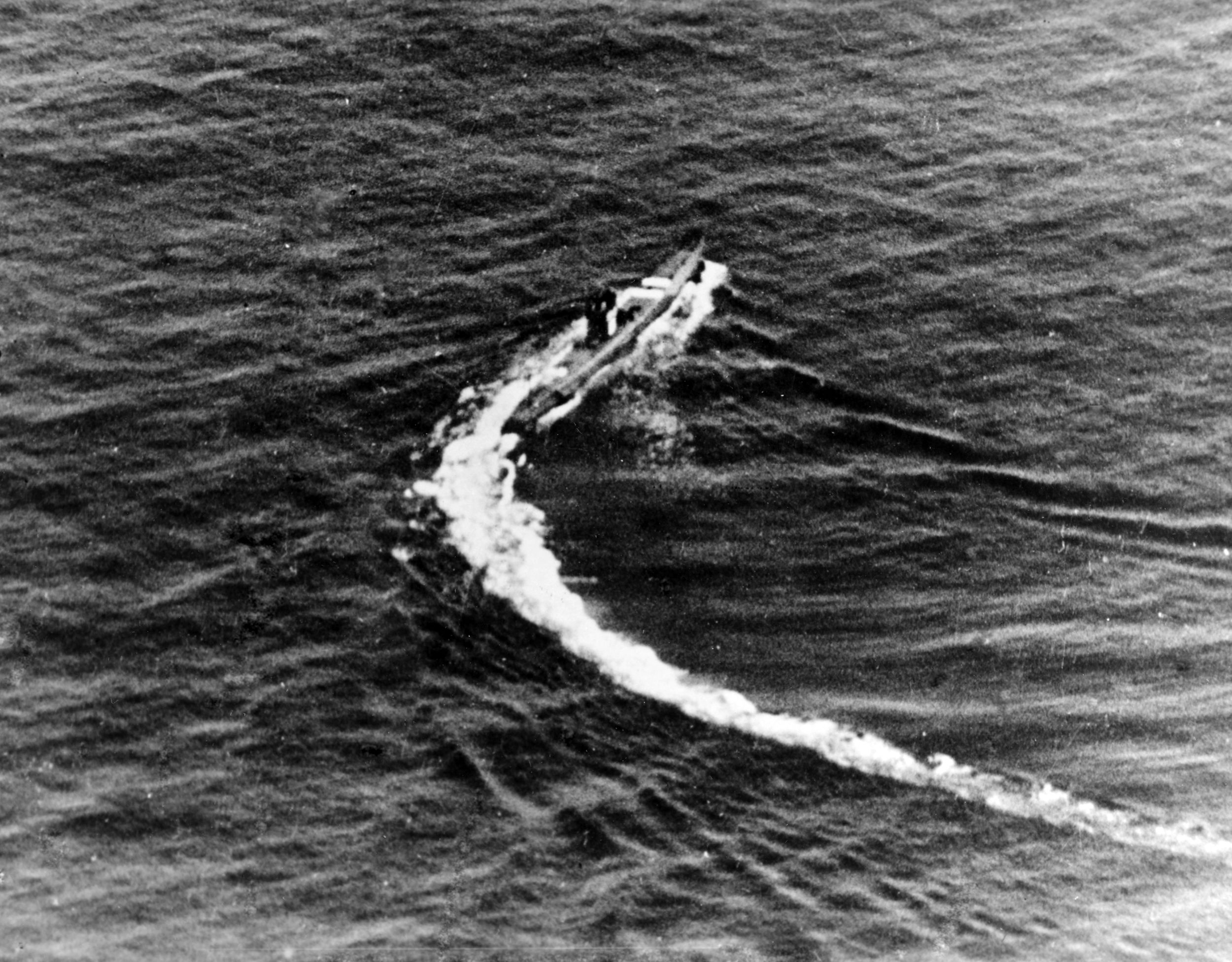 Photographed from an American aircraft preparing to attack, a Japanese submarine is maneuvering at high speed in this image taken in March 1943.