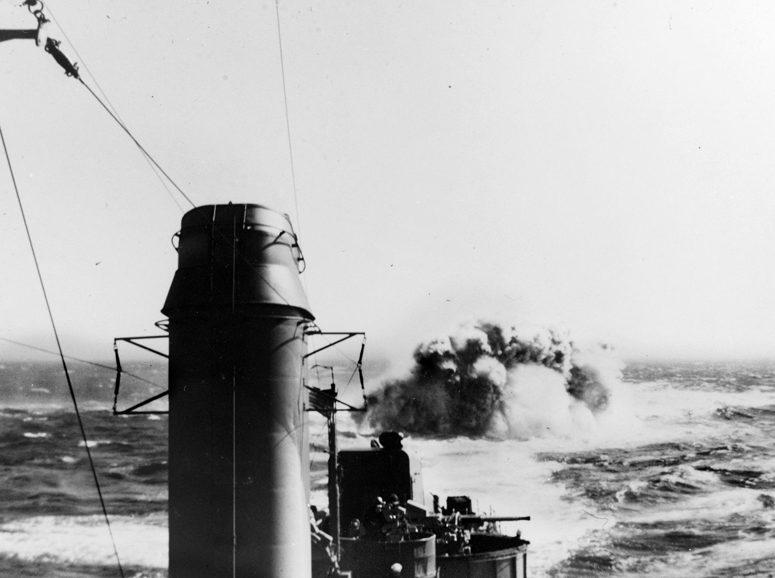A depth charge explodes astern of the destroyer USS Meade, one of the American warships of Destroyer Squadron 14 that sank the Japanese submarine I-35 near Tarawa atoll in November 1943. Both Meade and the destroyer Frazier picked up survivors after the sinking. 
