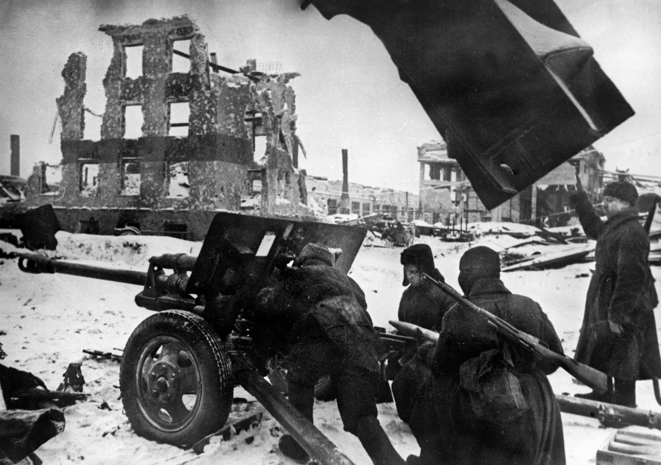 A Soviet gun crew poses in a photograph that was likely staged for propaganda purposes. During a lengthy siege, the Soviet Red Army compelled the German Sixth Army, trapped in the city of Stalingrad, to surrender.