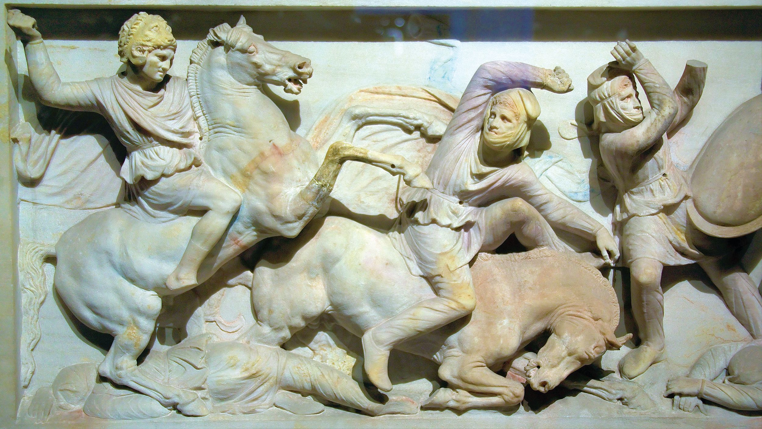 The marble Alexander Sarcophagus from about the time of Alexander, depicts him wearing a lion’s head helmet, in combat against the army of Darius III.