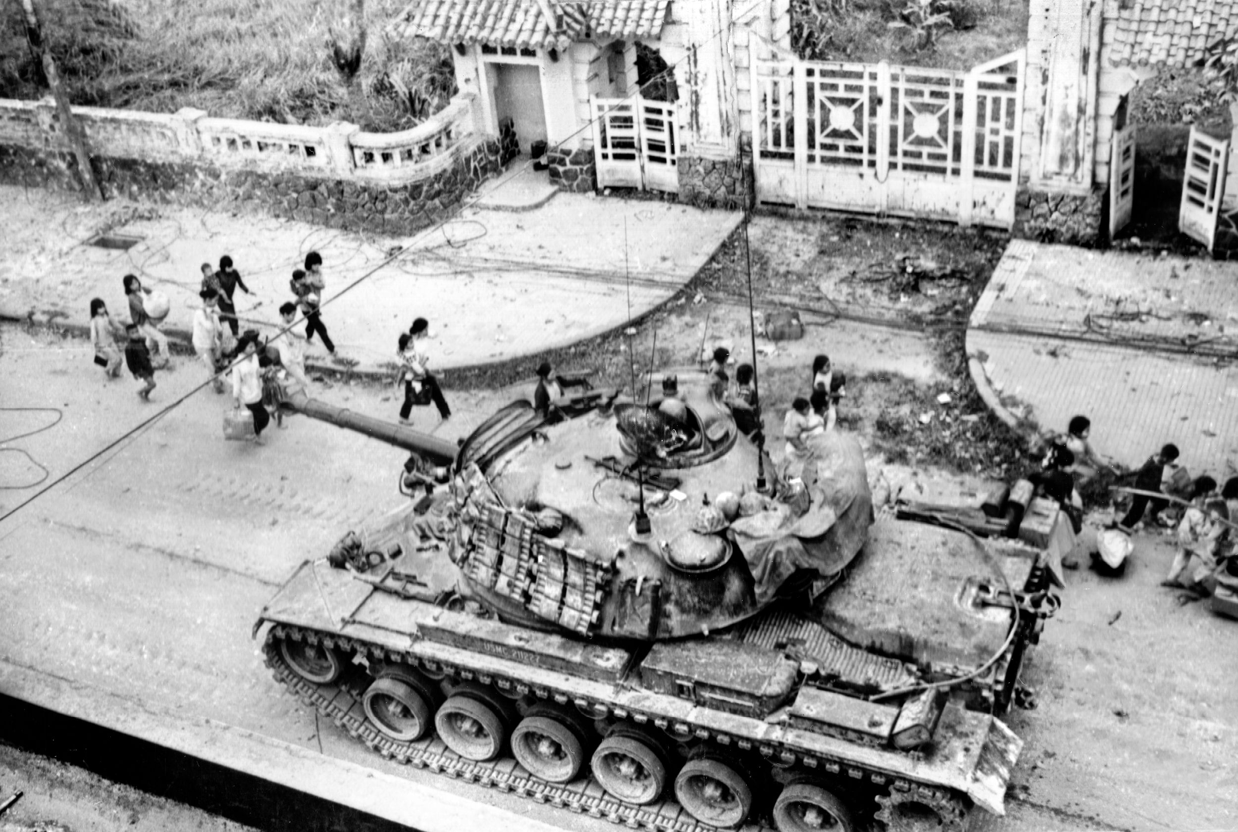 Refugees file past an M48 Patton Tank supporting the 1st Marine Division during the Battle of Hue City on February 3, 1968.