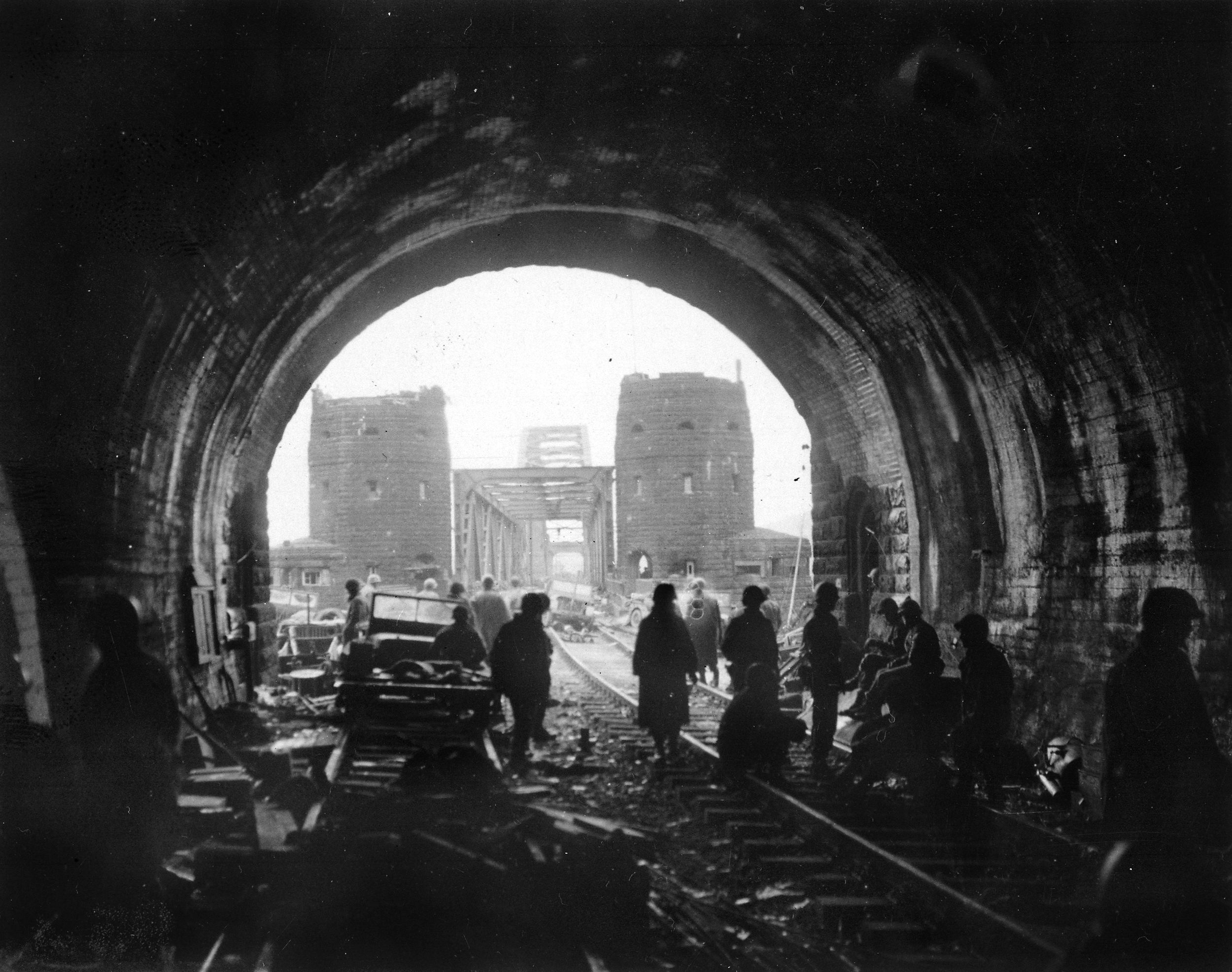 Men and equipment of the First U.S. Army  in the Erpeler Ley tunnel on the eastern side of  the Ludendorff railroad bridge over the Rhine River at Remagen Germany.  By 4 p.m., Lt. Karl Timmerman and his men had secured the bridge and the tunnel, not realizing it was more than 380 meters long and several hundred German civilians and soldiers were hiding deep in the darkness.