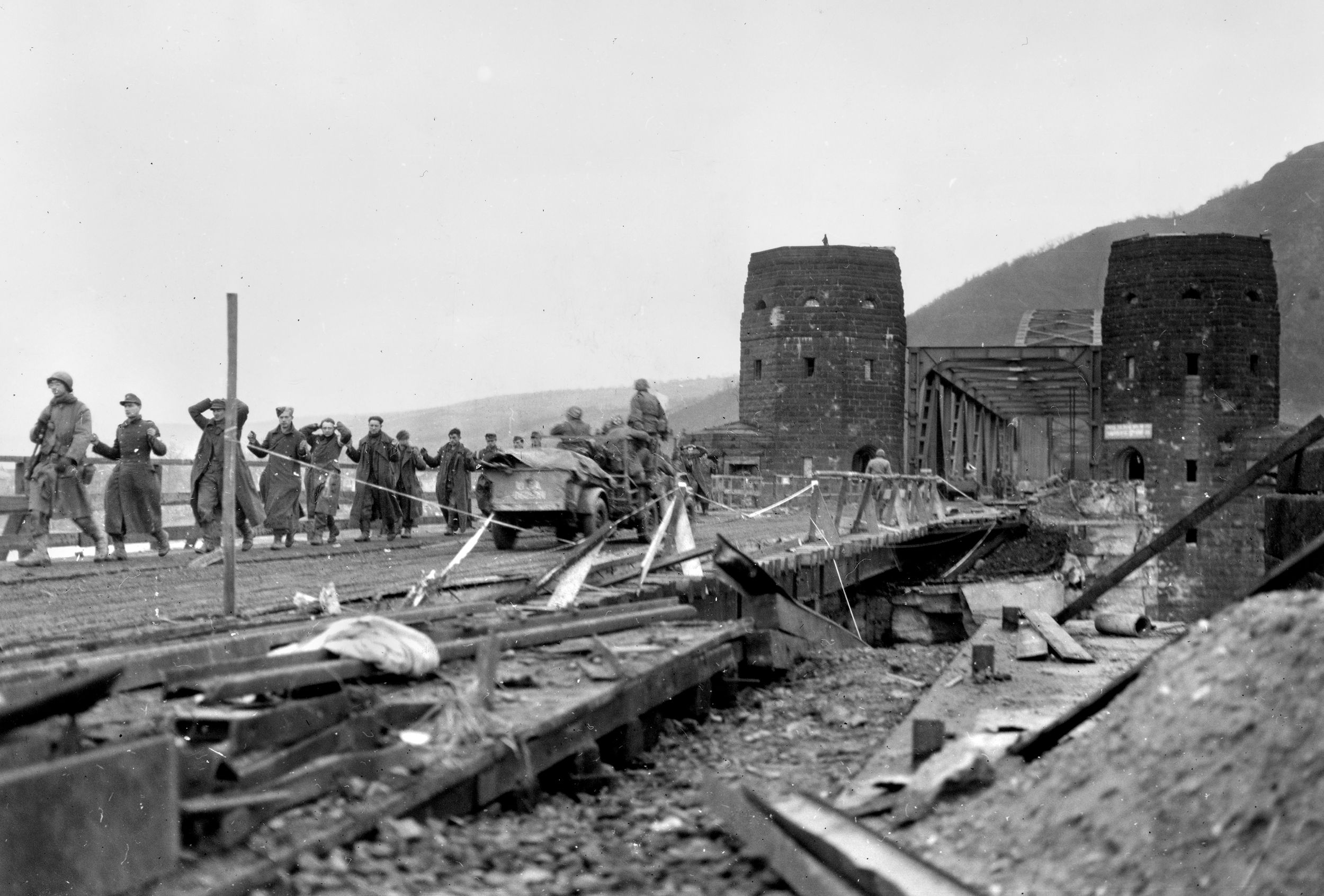 German POWs file across to the western end of the Ludendorff Bridge shortly after capture. German soldiers and civilians had been hiding deep in the Erpeler Ley railroad tunnel for several hours before surrendering.