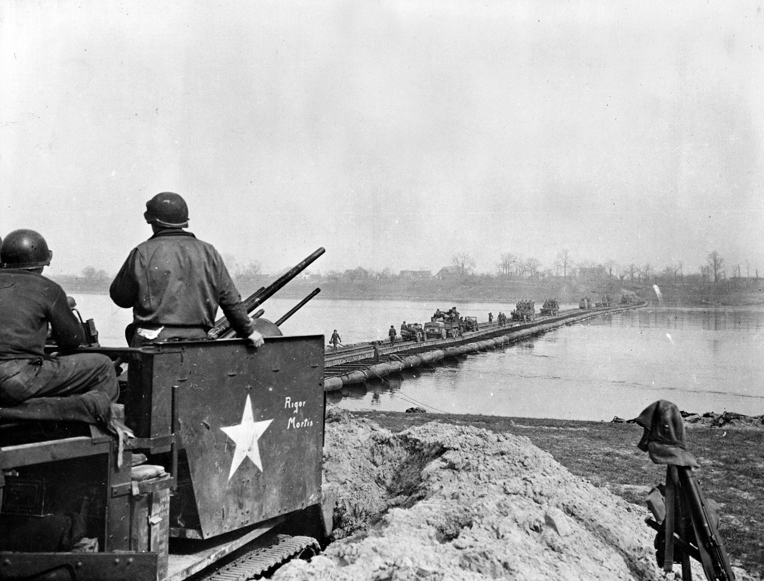 A U.S. antiaircraft battery guards a pontoon bridge built by the 291st Engineer Combat Battalion (ECB).  When weather cleared the Germans sent waves of aircraft to bomb the bridge, including Stukas and the jet-powered Ar-234, and the Me-262. Twenty-six aircraft were shot down over the course of two days, with more damaged. 