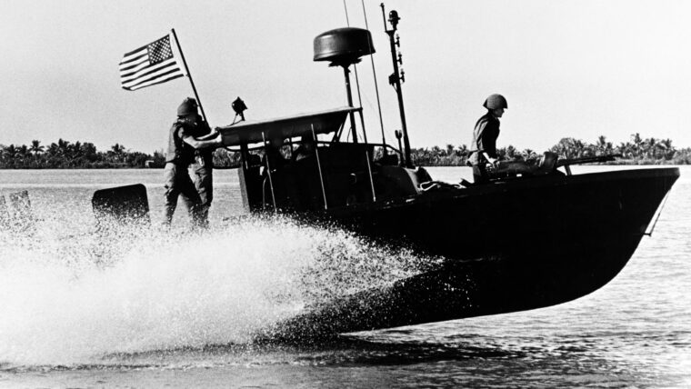 A U.S. Navy River Patrol Boat (PBR) of River Patrol Force 116 moves at high speed down the Saigon River in Vietnam, November 1967.