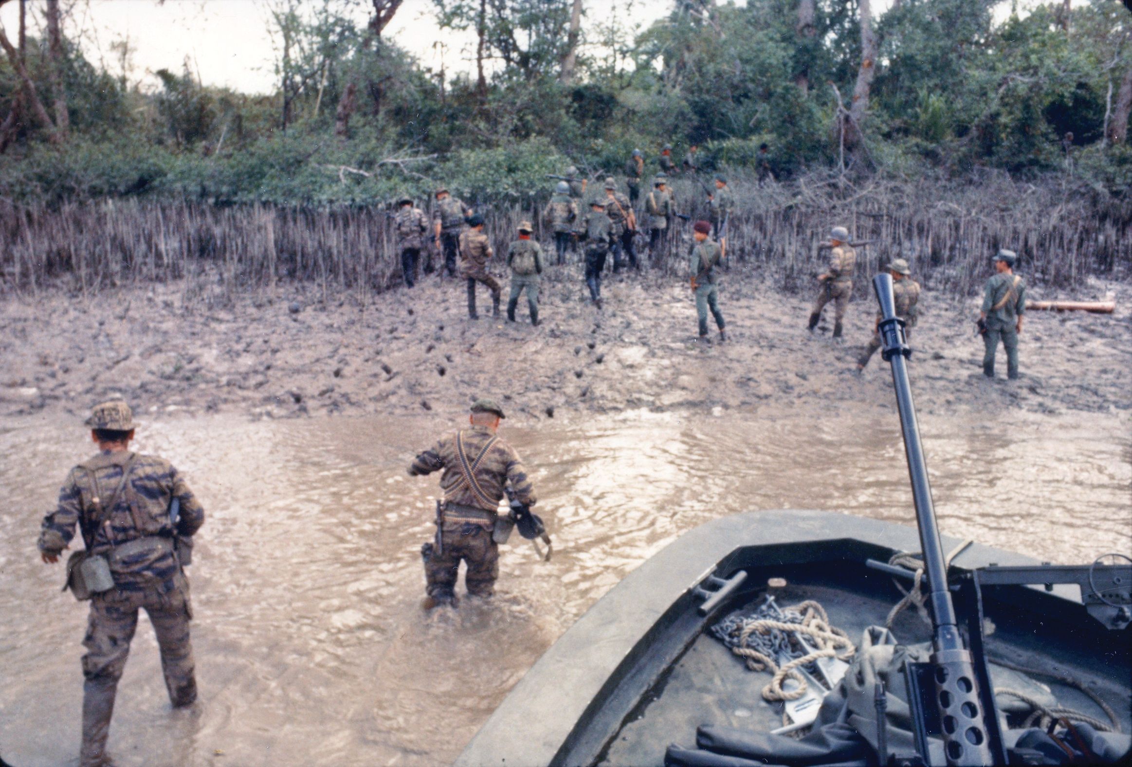 U.S. Navy Seal-Air-Land (SEAL) team members and South Vietnamese soldiers disembark from a river patrol boat (PBR) for an assault on Viet Cong positions on Tan Dinh Island in the Mekong Delta during Operation Bold Dragon III, March 26, 1968. 