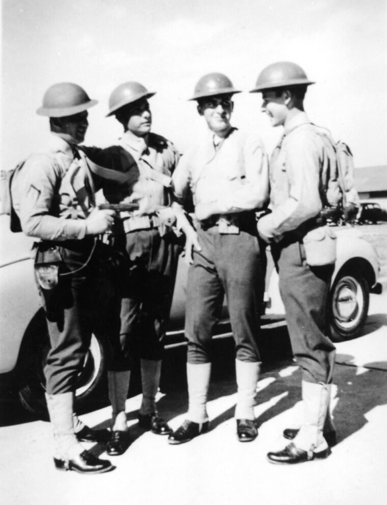 Corporal Ralph J. Holewinski converses with fellow gunners at San Diego in 1940.