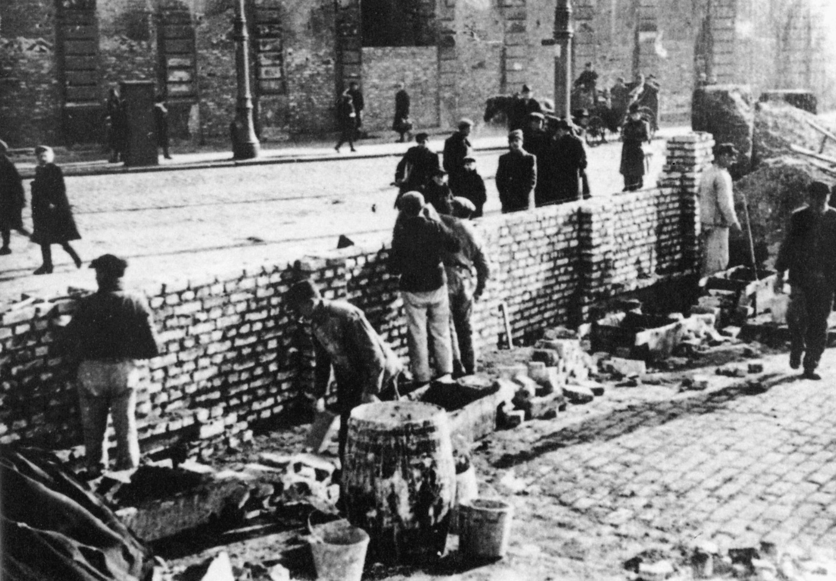 Jewish workers labor during the construction of the ghetto wall.