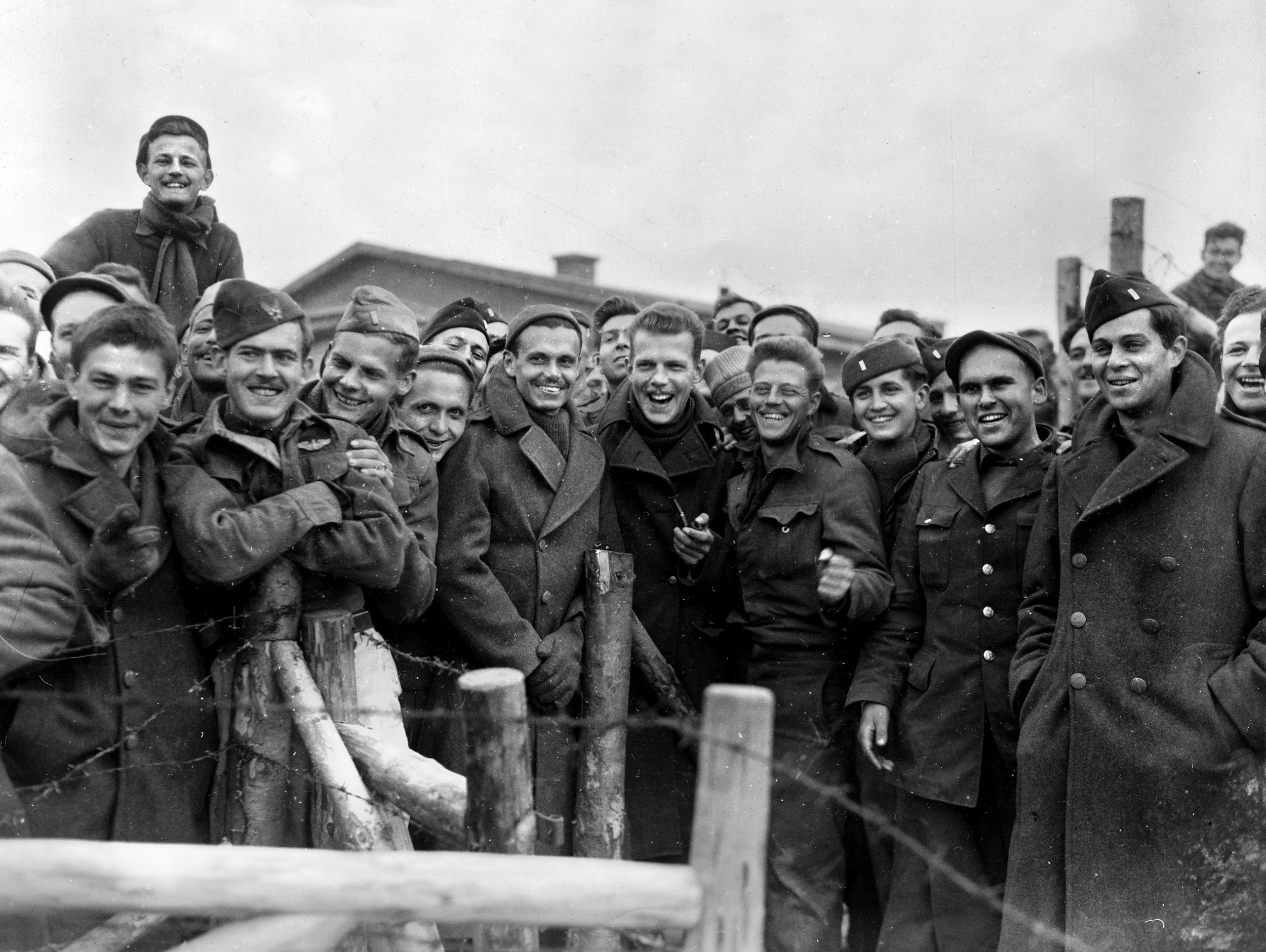 American POWs at Stalag VII-A react with joy at their liberation on April 29, 1945, by elements of the 14th U.S. Armored Division. General Patton soon arrived and saluted Ben Ernst as he walked through the liberated camp; Ernst never forgot the gesture.
