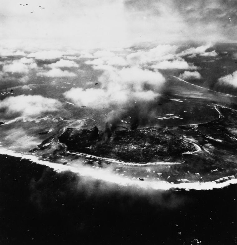 U.S. Navy landing craft approach the islands of Namur (center) and Roi (right), part of the Kwajalein Atoll in the Marshall Islands on February 1, 1944. Serving with the reconnaissance company of the 24th Marine Regiment, Marvin arrived the night before the U.S. invasion, where he endured the Navy shelling of the island. Smoke from the bombardment can still be seen rising from Namur Island.