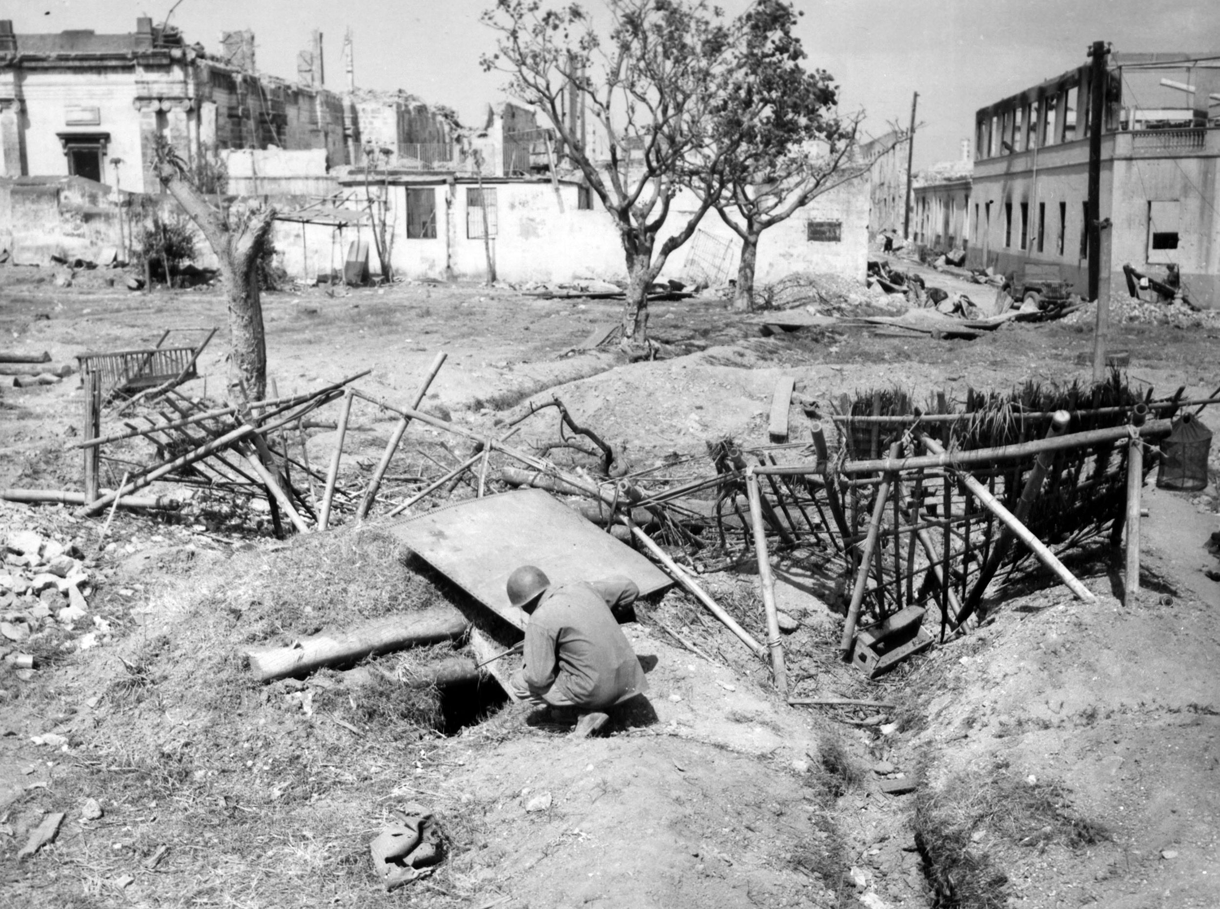 The Japanese had prepared substantial defenses at the Intramuros in Manila, and many of them were willing to die in the subsequent fighting. American troops were compelled to search house to house through the maze of defenses, continually under fire, and kill 67 Japanese soldiers before the positions pictured were secured.