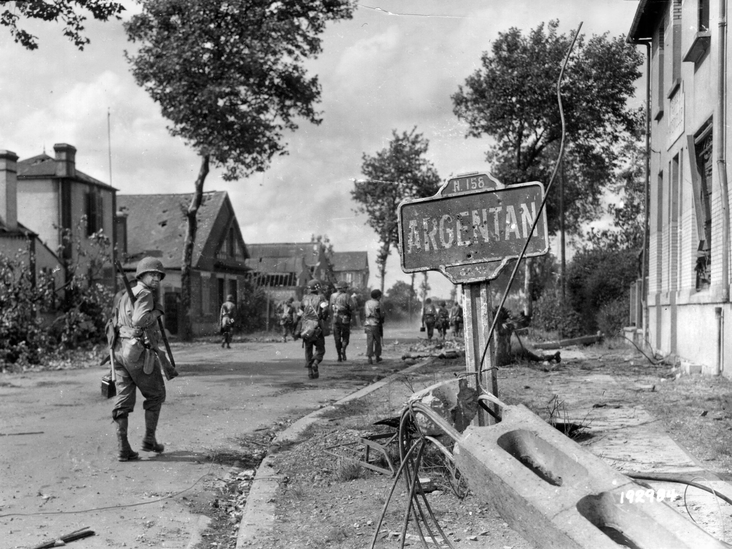 American infantrymen, probably from the 80th Division, enter the city of Argentan, France, after bitter fighting in the area. This photo was taken on August 20, 1944, as German troops were retreating during the Normandy campaign.