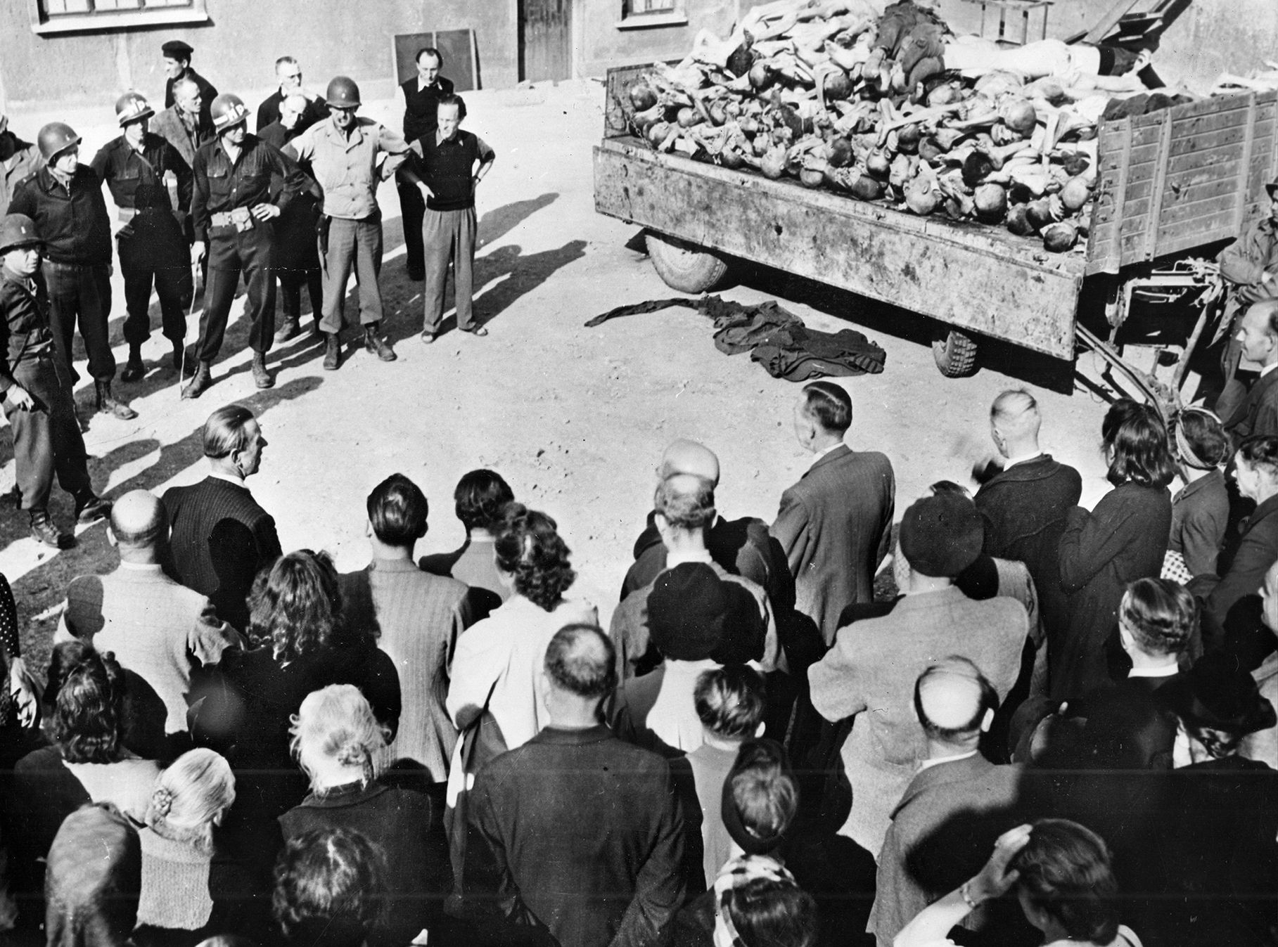 Elements of the Third Army, including the 80th Infantry Division, witnessed the horrors of the Buchenwald concentration camp, liberated on April 12, 1945. In this stark image, German civilians from the area surrounding the camp are forced to view the bodies of victims of the Nazi cruelty. They were brought to the camp under U.S. military escort. 