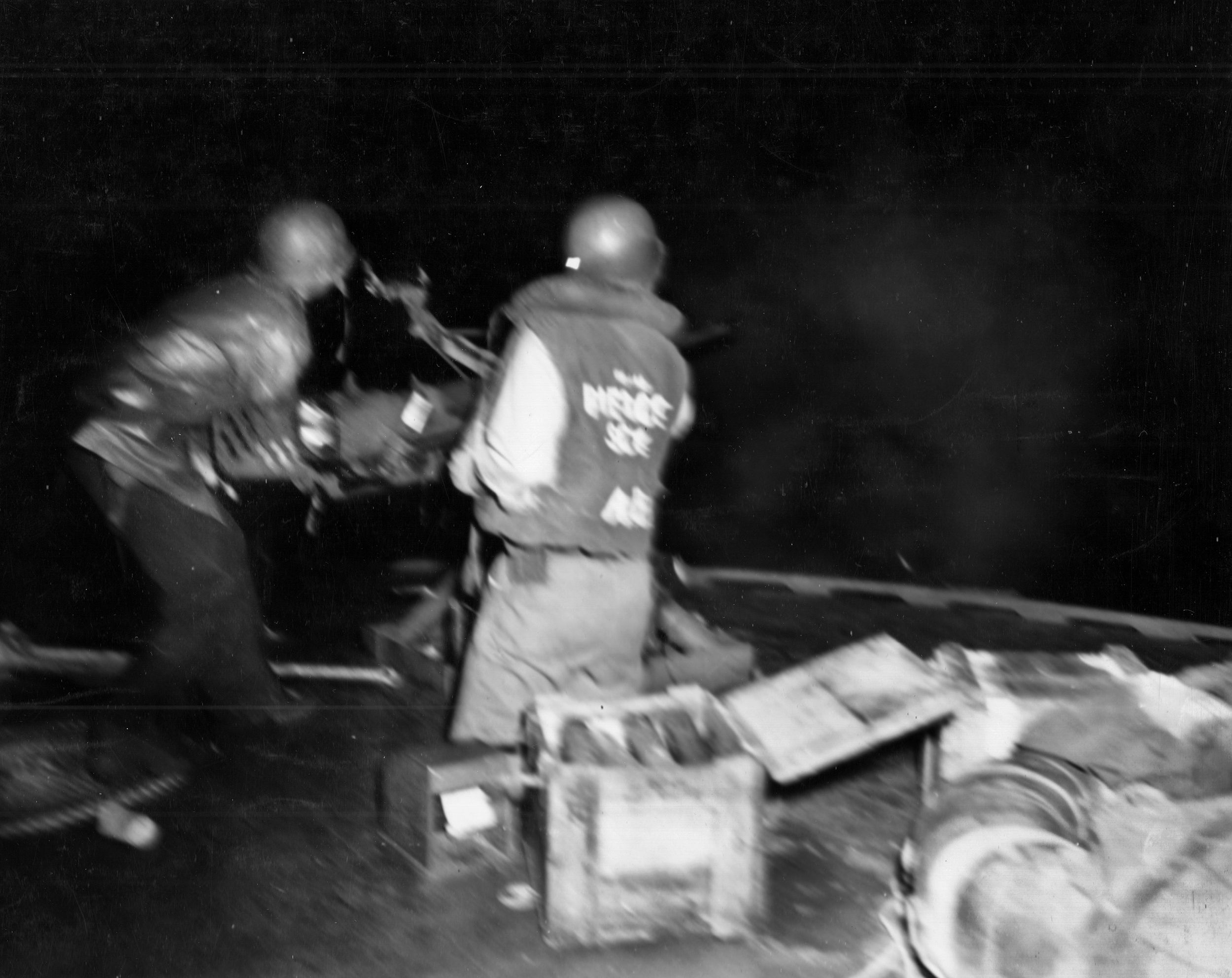 Its blast causing the camera to twitch, blurring the image, two PT-boat sailors fire what is most likely a .50-cal. M2 Browning machine gun during a night engagement. The PT-boats were small but swift and heavily armed.