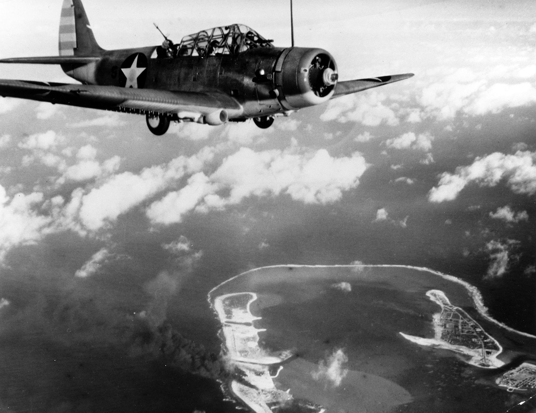 A Douglas TBD Devastator torpedo bomber over the Japanese-held Wake Island atoll during a raid on February 24, 1942. Obsolescent as World War II began, the Devastators suffered heavy losses during the Battle of Midway four months later.