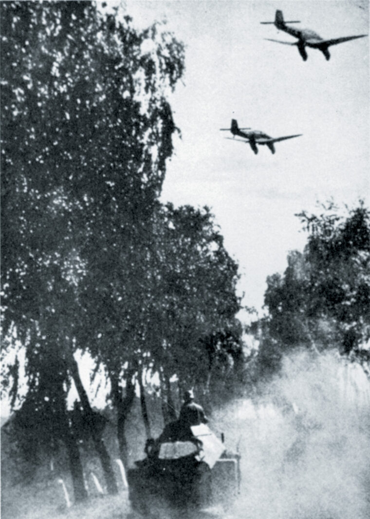 Stuka dive-bombers head into an attack on Polish troops and supply depots, while a German armored car follows along a dusty road. 