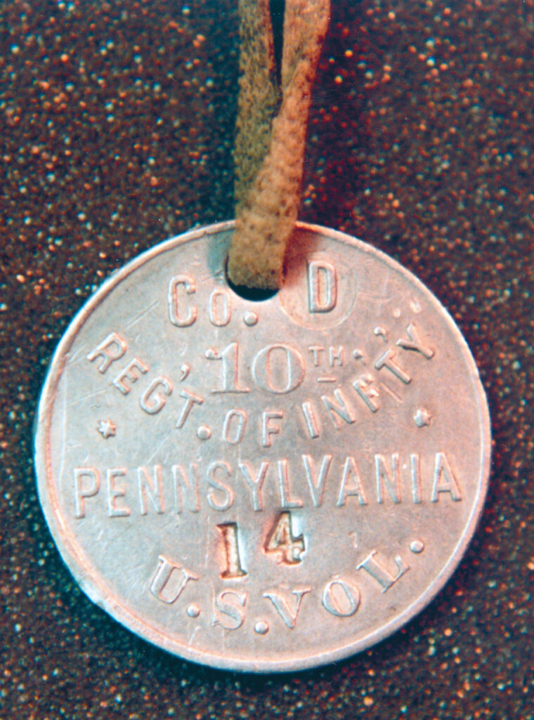An aluminum tag given by the Red Cross to soldiers headed for the Philippines in 1898. 