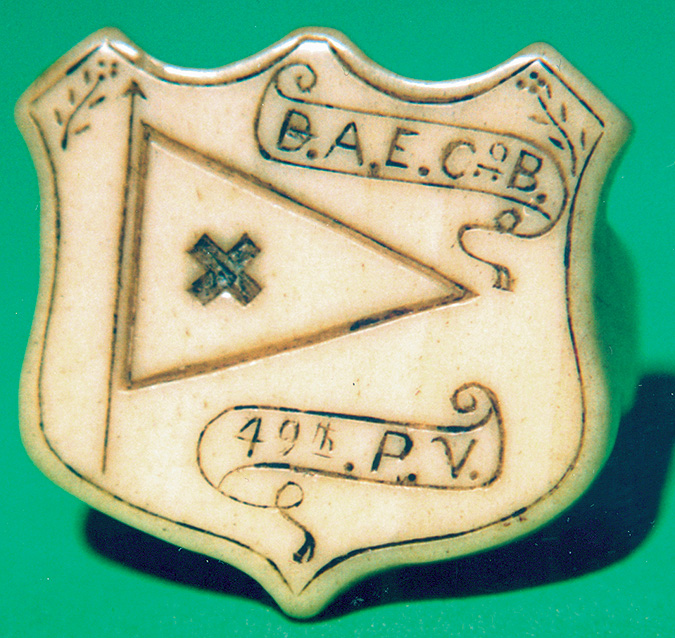 A Civil War soldier made this carved bone neckerchief slide that bears his initials, unit, and VI Corps flag.