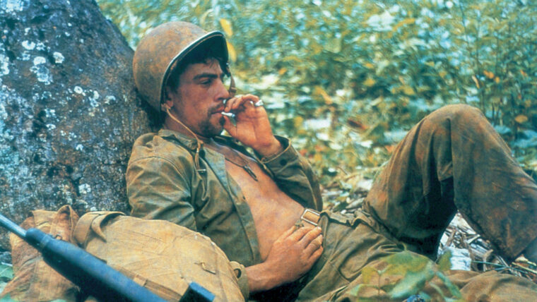 A WWII Marine corporal relaxes on Guam in 1944. His dog tags are visible around his neck.