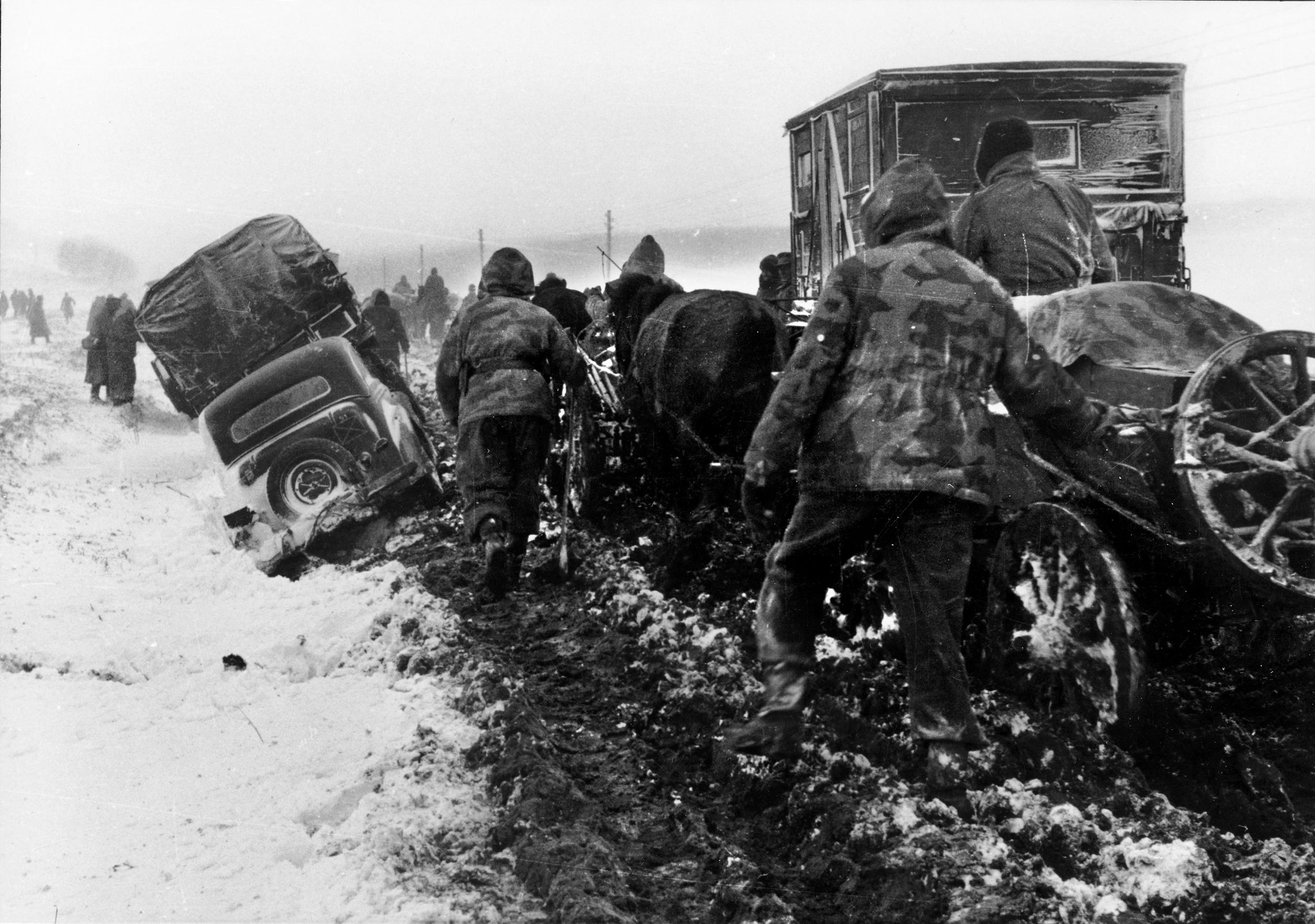 Soldiers with horse and cart retreating in the Ukraine in the winter of 1944. The mud would be a constant problem for both armies. Even tracked vehicles were prone to bogging down, consuming five times the normal amount of fuel. At times, only horses and men marching—sometimes barefoot, having lost their boots in the knee-deep mud—could get through. More of the wounded died during the slow evacuations.