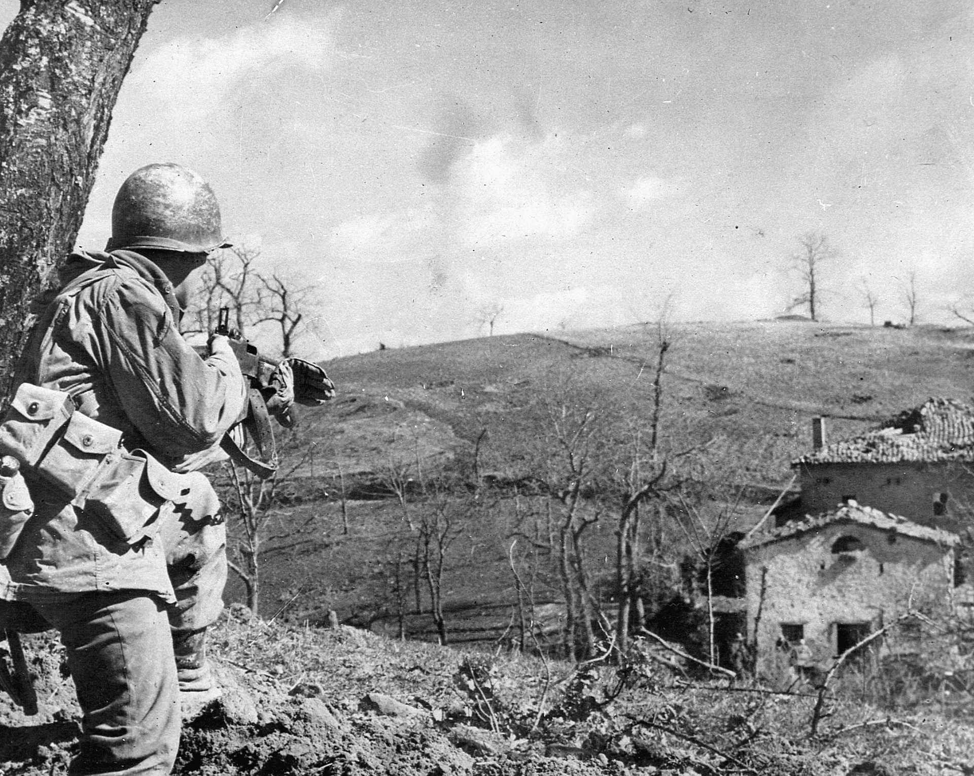 As his comrades root out enemy combatants from a house in Bologna, a U.S. soldier provides cover. 