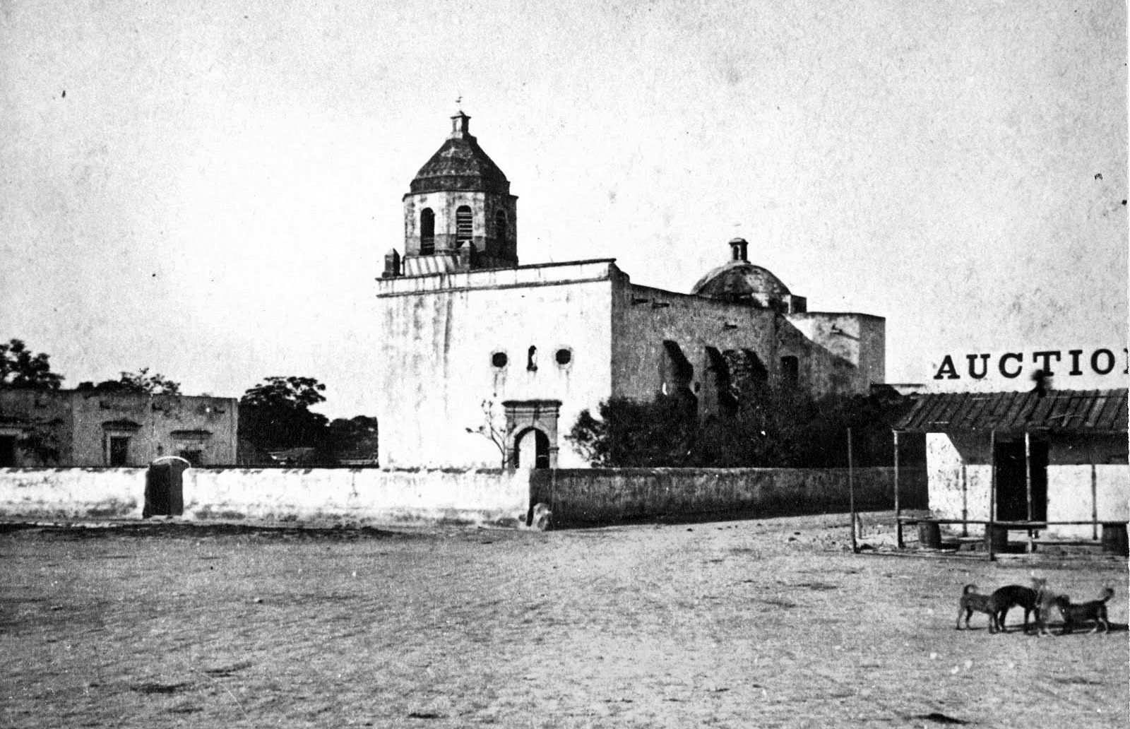 This early photograph is believed to be the Council House, a one-story 18th century stone building directly across from San Fernando Cathedral on the east side the Main Plaza in San Antonio, Texas. The building, which served as the courthouse with the local jail adjoining it, was the site of the 1840 meeting between Texas representatives and the Comanche delegation.