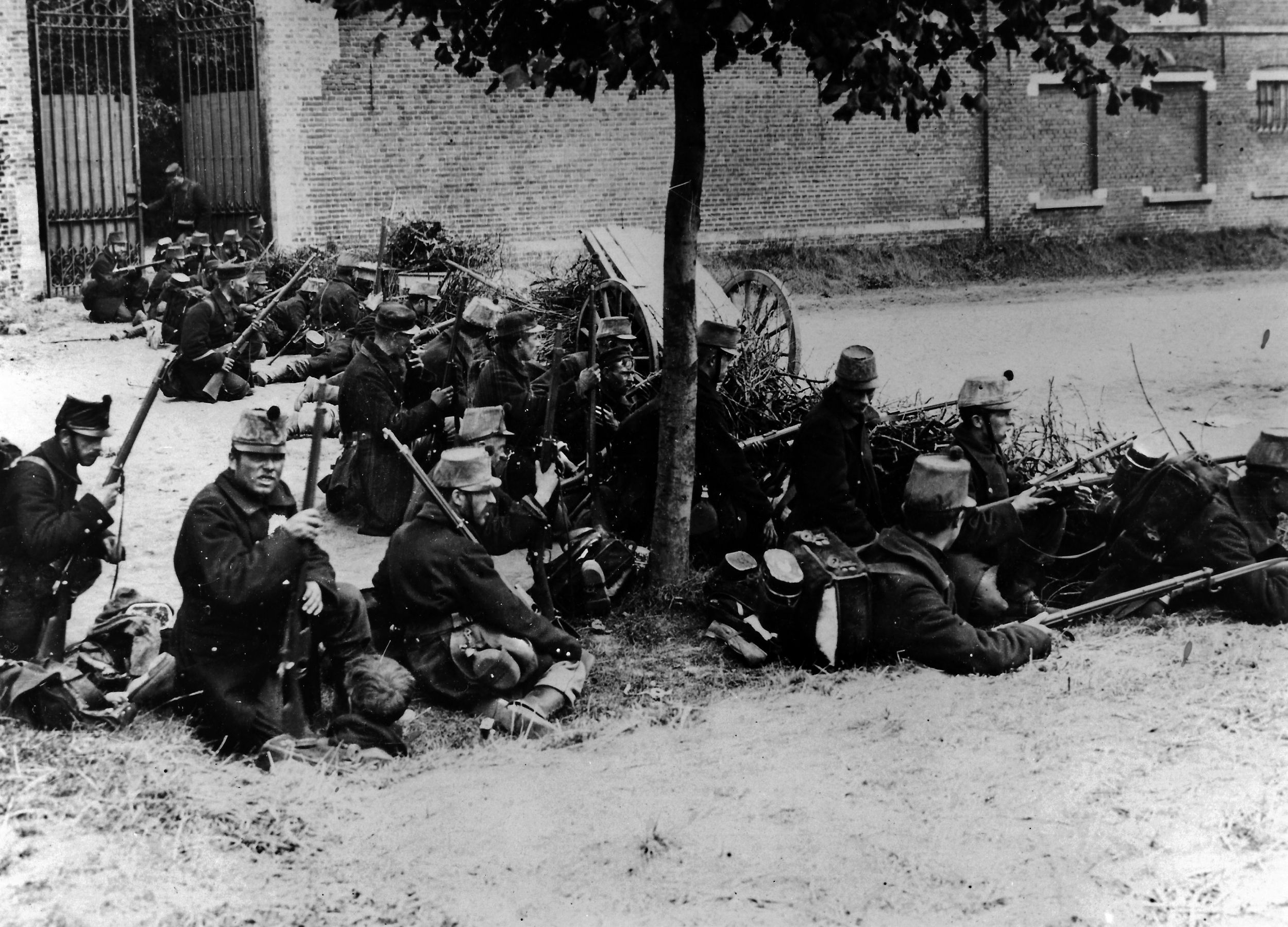 Belgian infantry await the invading Germans at an improvised roadblock. Vastly overmatched, the Belgians fought valiantly to defend their homeland.