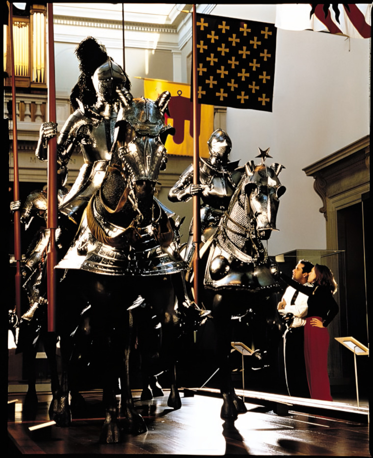 Knights and their armor-clad chargers pose  in all their shining glory among the banners and high win- dows of the Equestrian Court at the Metropolitan Museum in New York City.  The museum holds an exquisite collection of arms and armor.
