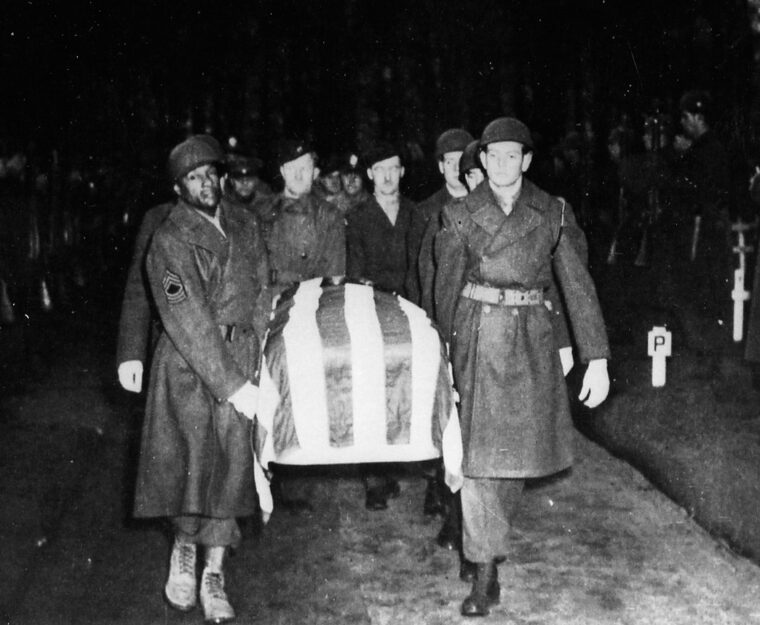 U.S. Military personnel shown with Patton’s flag draped casket. 