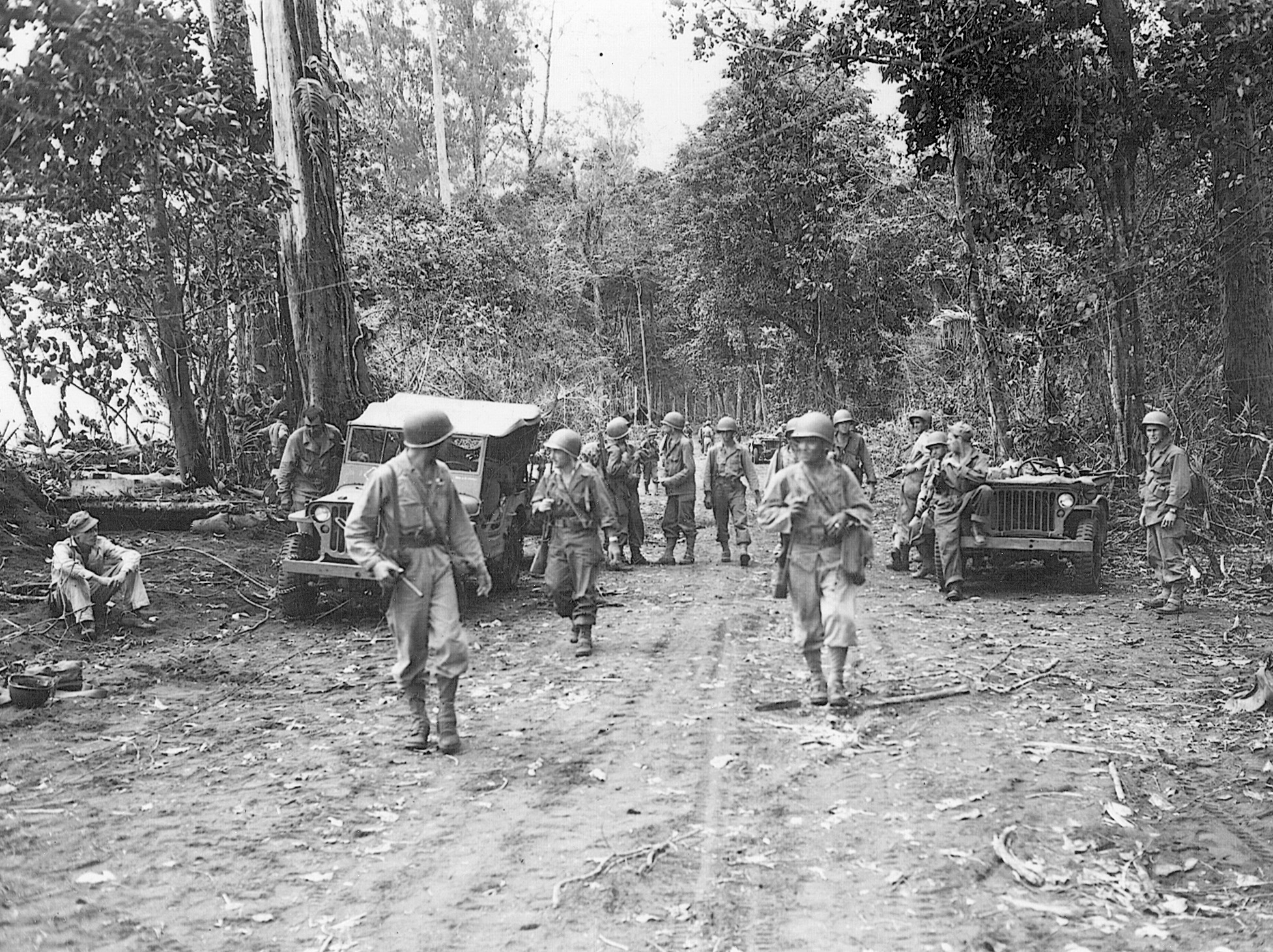 Soldiers of the 158th Regimental Combat Team, nicknamed the Bushmasters, advance up a road carved out of the Wakde Island jungle on June 9, 1944.