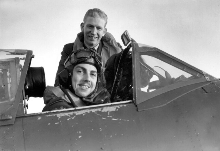 Flying Officer G.A. Daymond (seated in cockpit) and Flight Lt. C.G. Peterson of the Eagle Squadron were both awarded the Distinguished Flying Cross. 