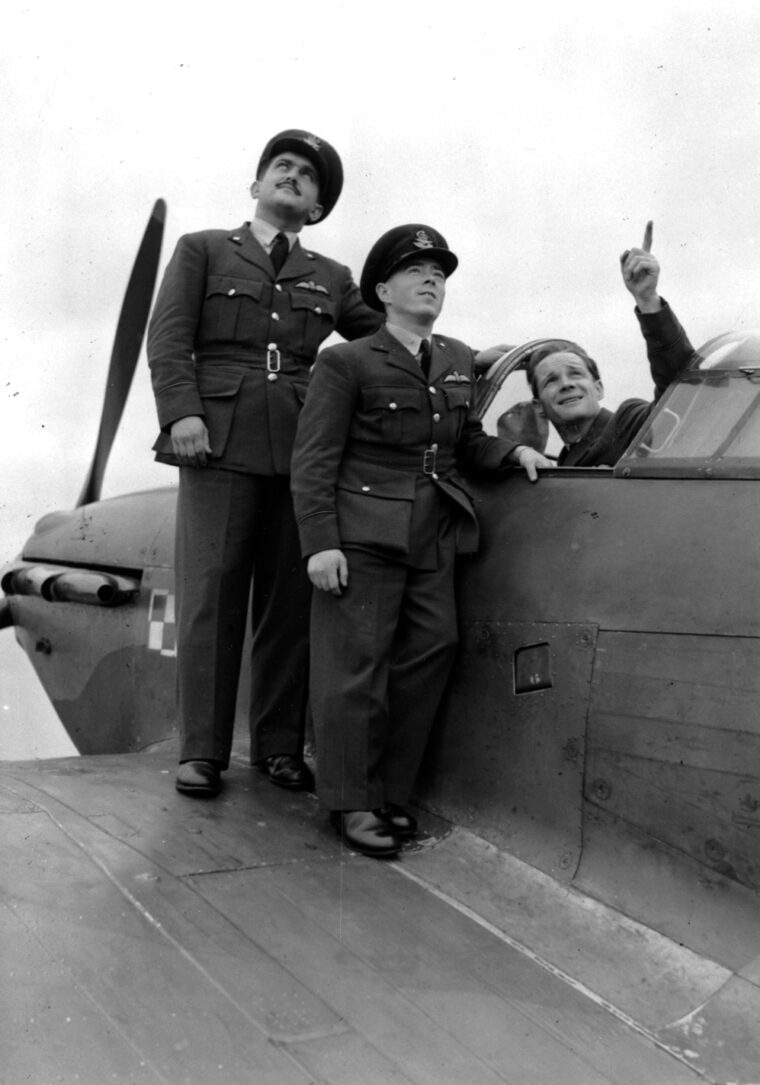 Pilot Officers Andrew Mamedoff, Vernon Charles Keough, and Gene Tobin gaze skyward hours before they began flying fighter planes for the RAF. 