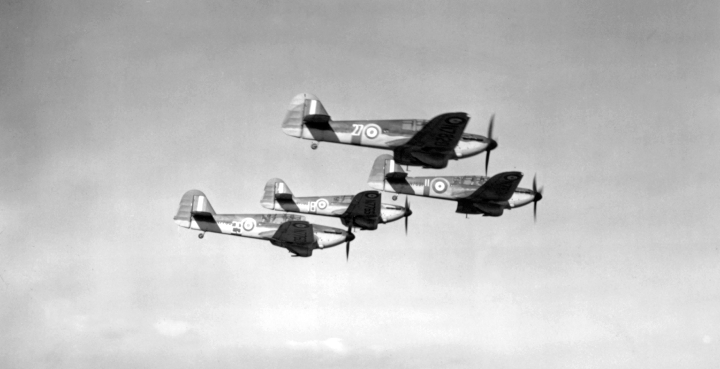 Prospective Eagle Squadron pilots were required to undergo standard RAF flight training even though they already held certifications. In this photo American pilots fly trainers in formation above an RAF flight training school.