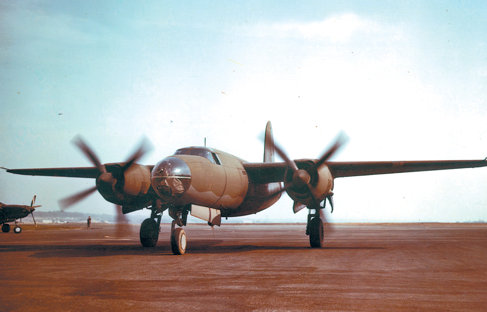 The tricycle landing gear of the B-26 Marauder is clearly visible as this plane taxis along a dirt airstrip. Although it was a challenge to fly, the B-26 proved itself a capable tactical bomber.