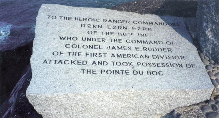 The memorial includes an inscription for Colonel James E. Rudder, who led the assault, and his Rangers.