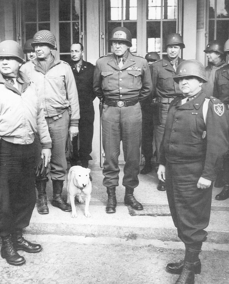 Maj. Gen. Walker (lower right) poses with his WWII mentor, General George S. Patton, Jr. (center), and his staff, which includes Patton’s famed English dog, Willie. 