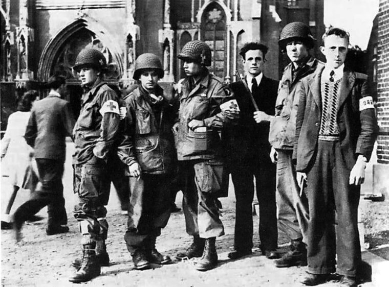 Members of the 326th Airborne Medical Company are shown at Veghel with fighters of the Dutch underground during Operation Market Garden, September 1944. Veghel was near the city of Eindhoven, where heavy fighting occurred. 