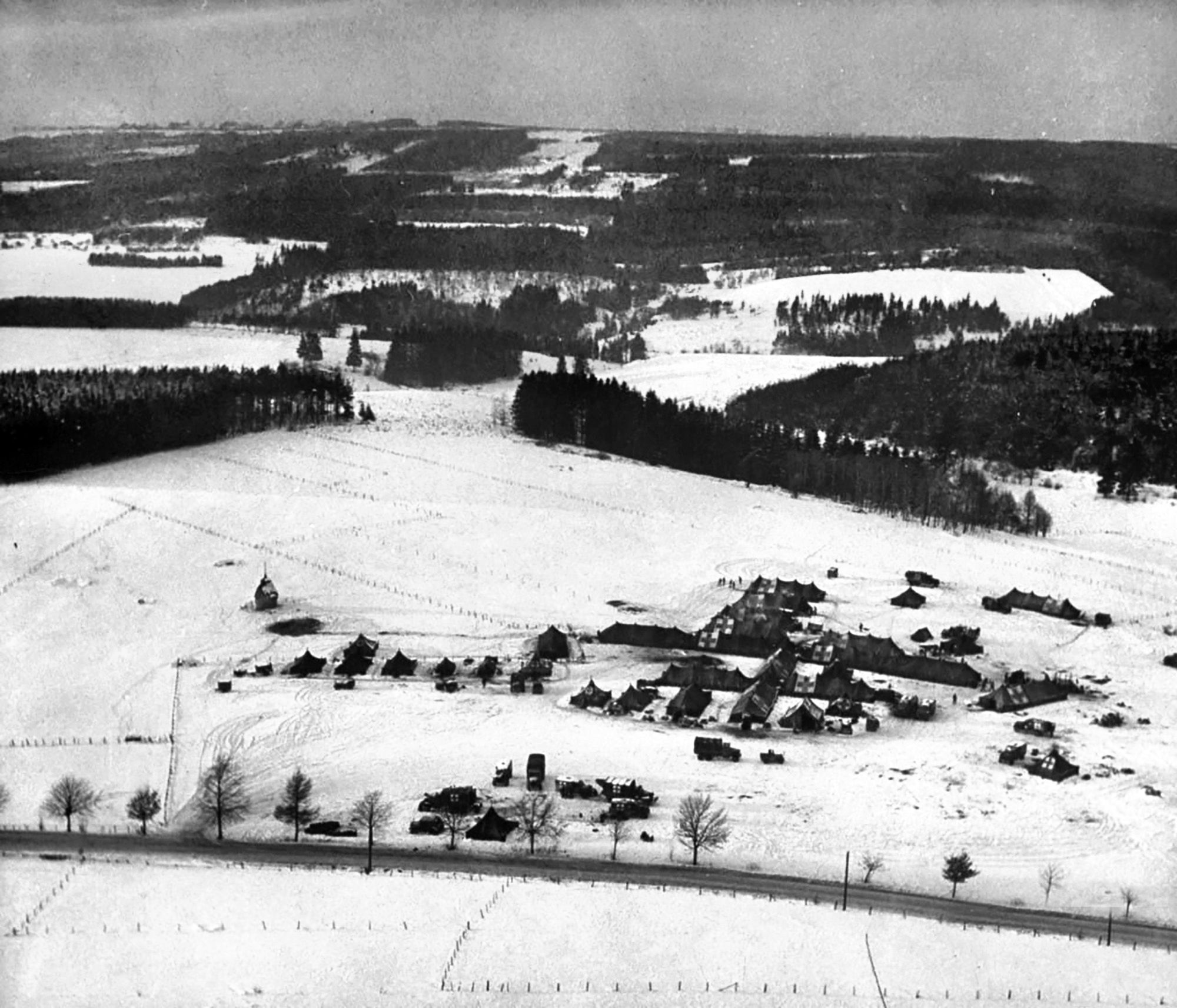 This aerial view of the 326th Airborne Medical Company was taken on December 18, 1944, near Sainte-Ode, Belgium. At 10:30 that night a German Kampfgruppe attacked the unit.