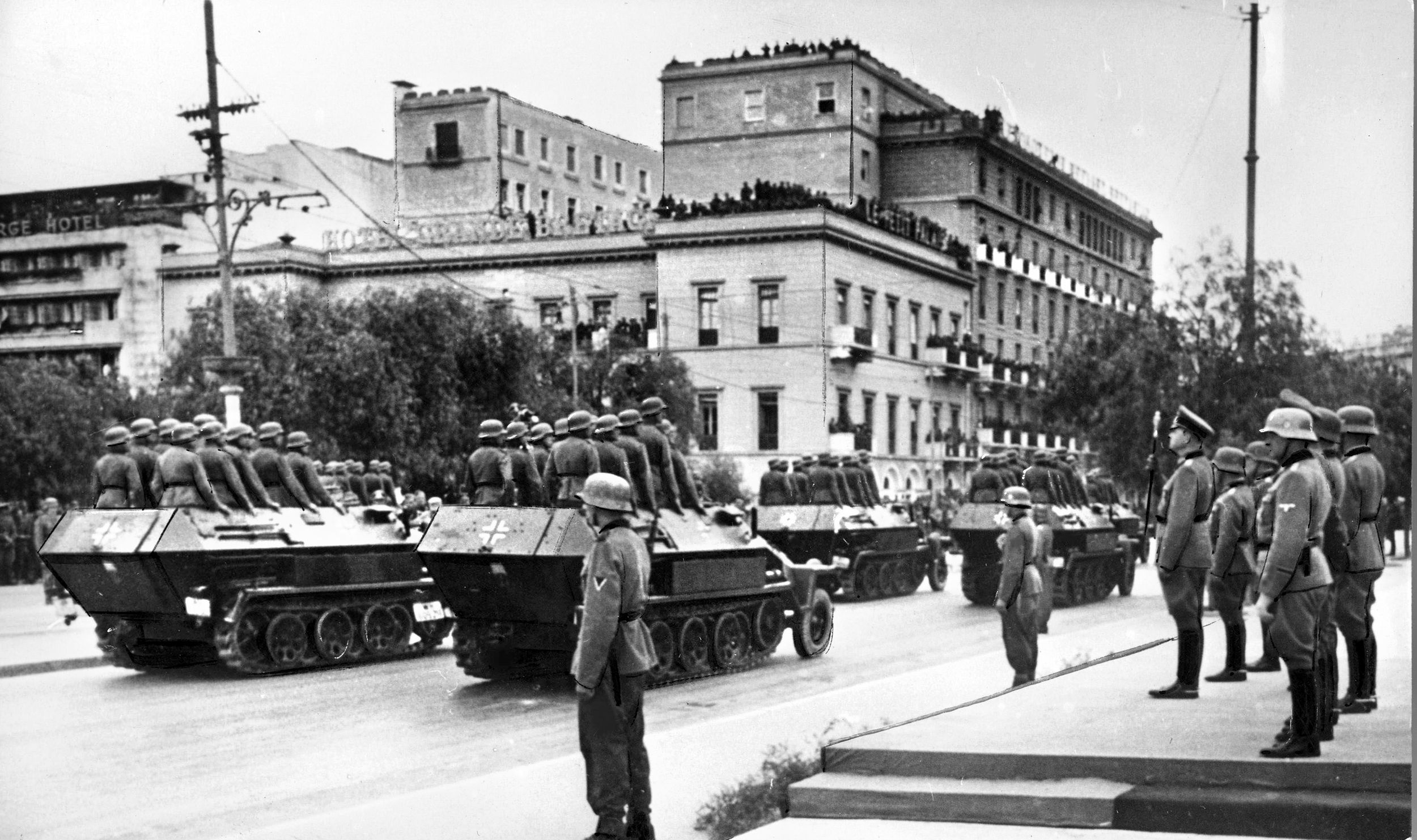 As Athenians watch from rooftops, German Field Marshal Wilhelm List (right) reviews troops during a victory parade in Athens, April 27, 1941—just 24 days after the German invasion. The Greek king and government fled to Egypt.