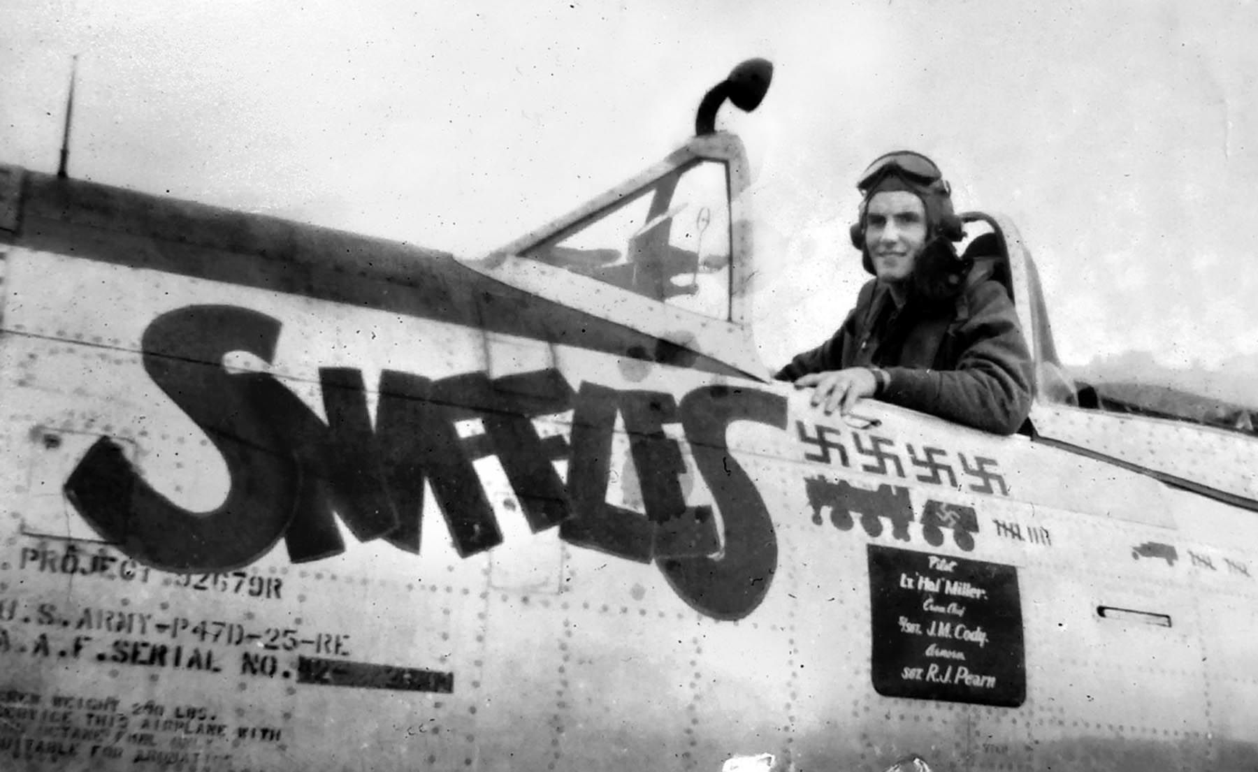 Lieutenant Hal Miller smiles from the cockpit of his P-47 ”Sniffles.” The four swastikas denote that he had shot down four German aircraft to date. He would gain another two, making him an “ace." 